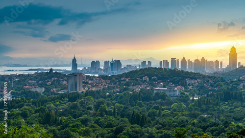 Εκτύπωση καμβά City Skyline Over Green Hills at Sunrise or Sunset