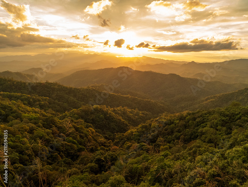 Blue golden sky sunrise dramatic beautiful landscape mountain. Dramatic sunset over mountain landscape. Beautiful landscape foggy hills twilight time. Dawn sky gold dusk time cloudscape with sunlight