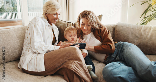 Принти на полотні Happy, family and toddler at house with phone, baby pictures and watching cartoon for bonding
