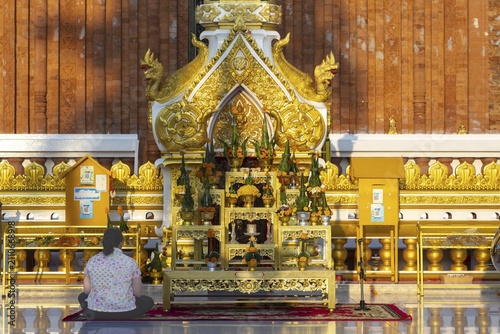 Altar for offerings to Buddha, Dharma and Sangha, in front of the chedi at Wat Phra That Phanom, temple complex in Amphoe That Phanom, Nakhon Phanom Province, Isan, Thailand