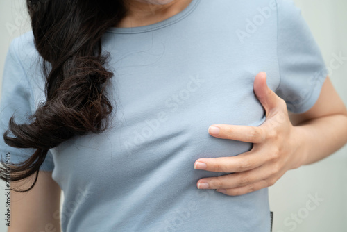 Asian woman self touching check lump or Breast cancer, Breast Self Exam.