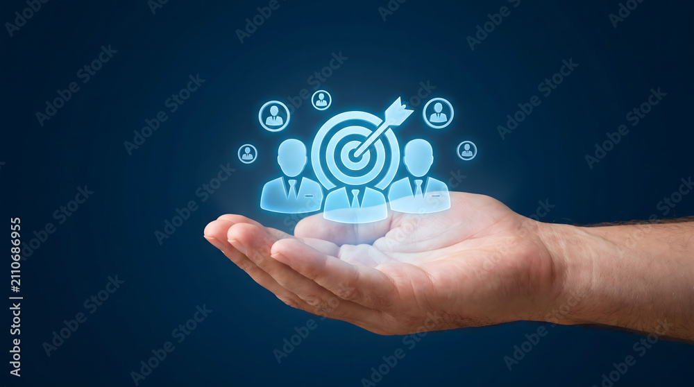 Fototapeta premium Hand holding glowing target with business people icons, target audience and customer focus, Digital human resources and team management concept.