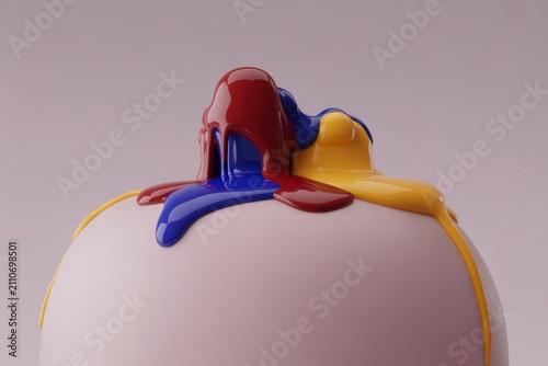 Primary red, blue, and yellow liquid paint elegantly cascades over the smooth surface of a white sphere