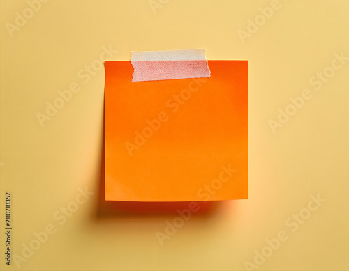 Orange sticky note on wall