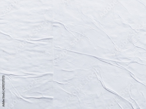 Фотография White folded paper poster background with abstract soft wrinkled texture