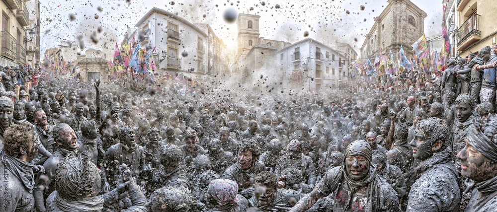 Naklejka premium Crowds covered in black paint during the Cascamorras festival in Baza