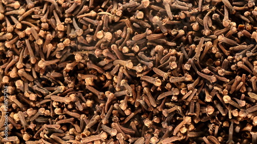Natural dried cloves displayed in macro detail with earthy texture. Aromatic spice suitable for cooking, herbal wellness, and beverage preparation.