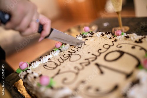 Hand cutting birthday cake for a celebration