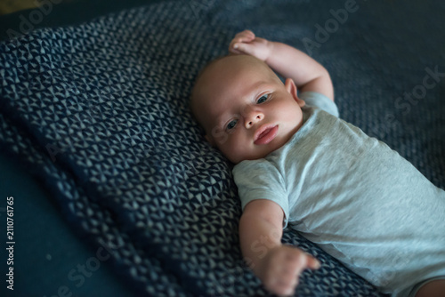 Photography Baby Lying On Sofa Looking At Camera