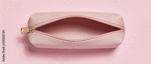 Minimalist pink zippered pouch with clean interior lining on soft pink background