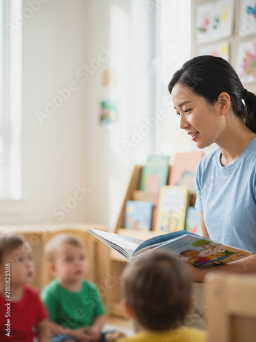 East Asian Chinese Female Teacher Reading Toddlers Children Daycare Early Childhood Education Storytime