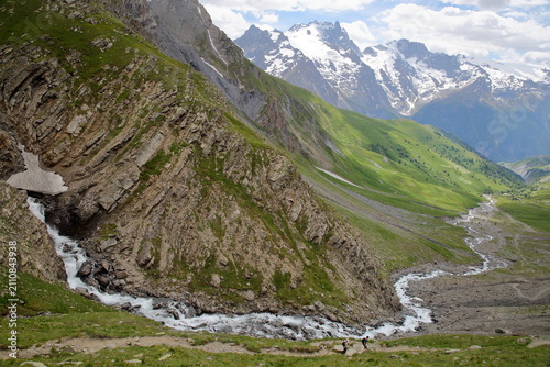 View from a hiking trail towards Valfroide Valley above La Grave village, Romanche Valley, Hautes Alpes (French Southern Alps), France, with the mountain stream Maurian and La Meije mountain range 