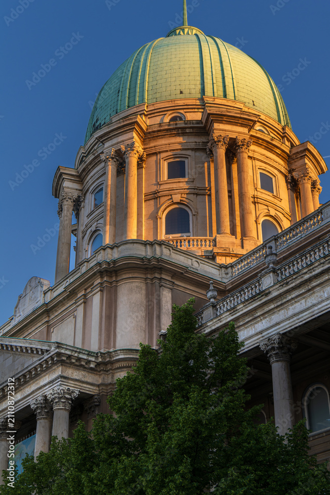 Fototapeta premium illuminated buda castle dome at golden hour in budapest