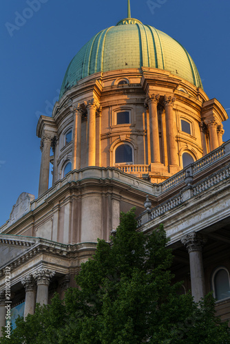illuminated buda castle dome at golden hour in budapest