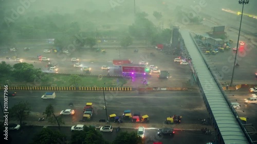 Heavy rain on a busy highway in India. Traffic moving through storm in Delhi NCR region.