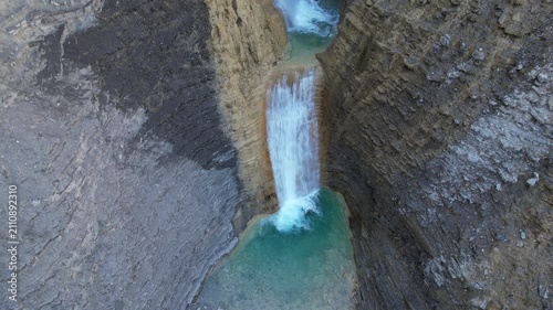 Rising up aerial shot of Oros Bajo waterfall. Huesca, Aragon, Spain.