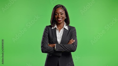 Professional African American Businesswoman Standing With Arms Crossed Over A Green Screen Background