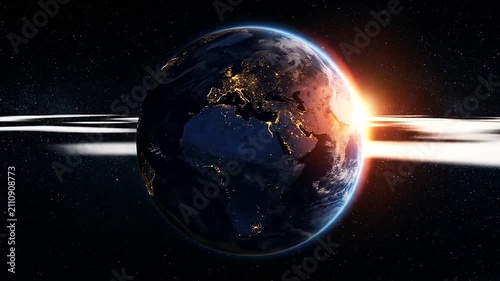 A glowing planet earth seen from deep space at sunrise