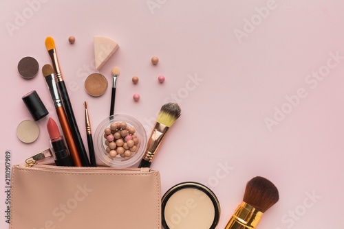 Принти на полотні Assorted makeup tools and brushes on soft pink backdrop.