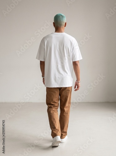 Back view of man wearing blank white t-shirt mockup