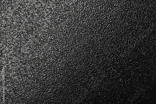 Close-up of a black powder coating textured surface showing rough grain, fine detail and abstract monochrome pattern ideal for backgrounds, design overlays, and industrial or minimalist visual themes