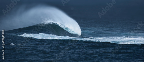 Powerful Ocean Wave Breaking in Stormy Sea with Dramatic Sea Spray
