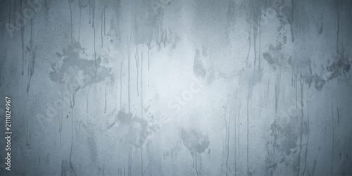 Photos A textured concrete wall with a distressed, grunge-like appearance, featuring smudges and streaks, evoking a sense of urban decay or abstract art