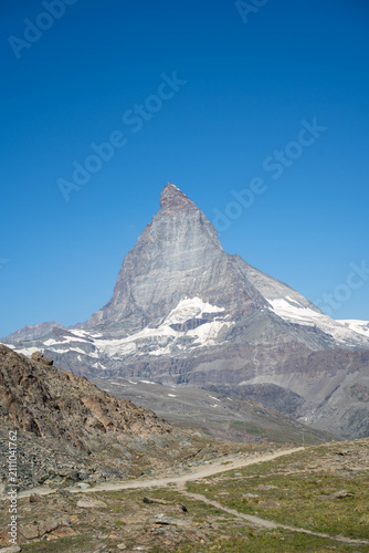 Majestic Matterhorn peak reflection in Riffelsee lake near Gornergrat, Zermatt, Swiss Alps in summer