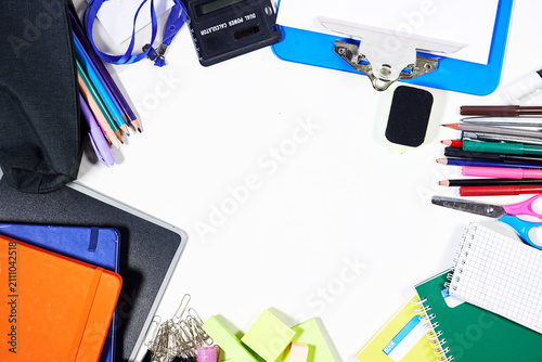 Flat Lay School Supplies and Stationery On White Desk With Notebooks, Pencils and Clips
