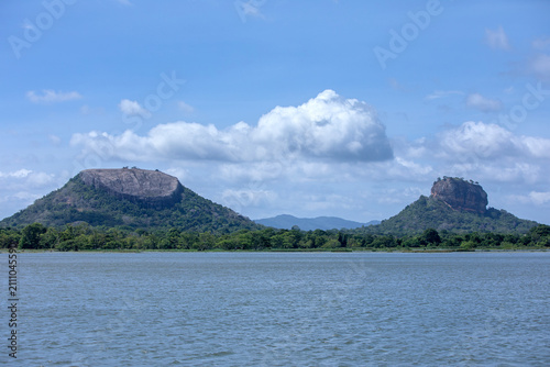 A view from Thalkote Lake at Sigiriya in Sri Lanka looking towards Pidurangala Rock and Sigiriya Rock. Both of these granite inselbergs are fomer magma plugs of volcanos.