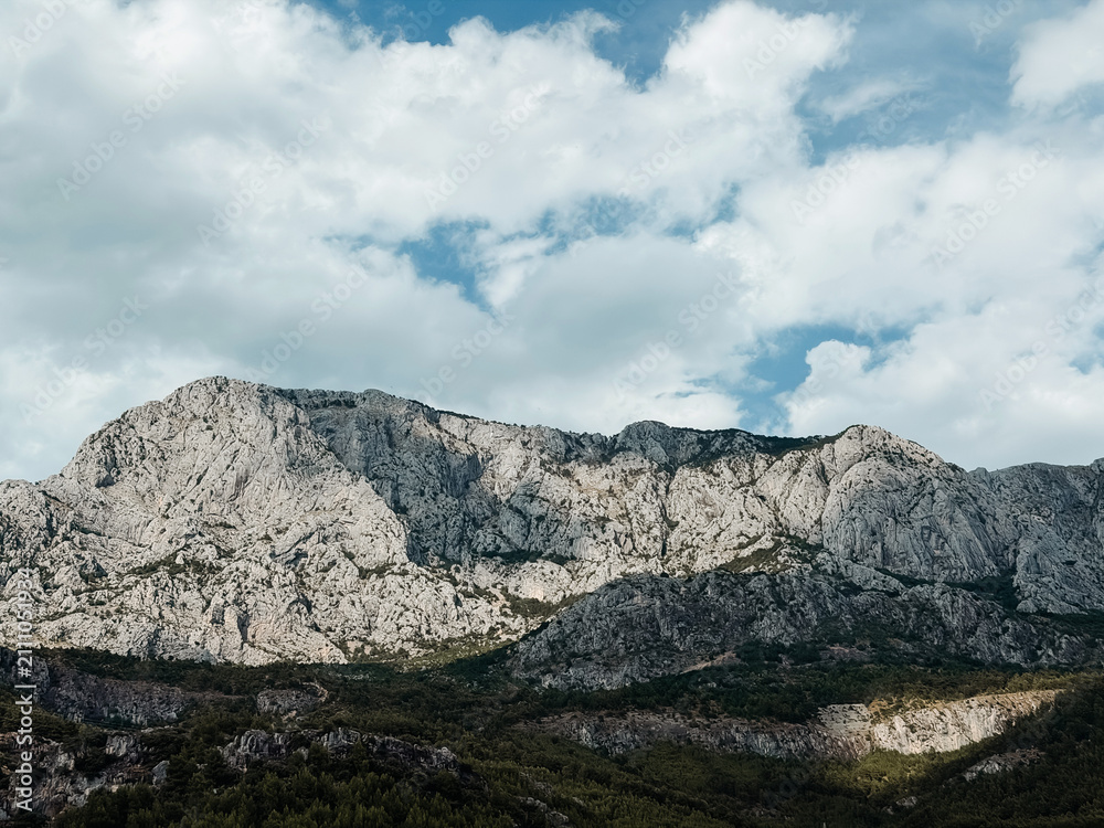 Fototapeta premium Majestic limestone peaks of Biokovo mountain ridge under dramatic sky in Croatia, perfect for hiking