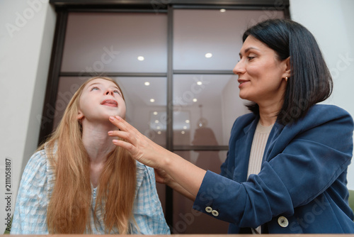 Принти на полотні Smiling female speech therapist uses laptop computer for teaching