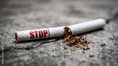 Close up of damaged cigarette with bold stop warning beside loose tobacco on rough background symbolizing quitting smoking harmful habit awareness addiction control healthier lifestyle decision change