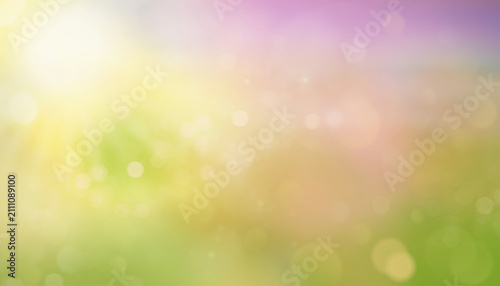 Abstract blurred sunny background with soft yellow, orange, and green tones. Bright bokeh light and warm sunshine create a cheerful and dreamy summer or autumn atmosphere