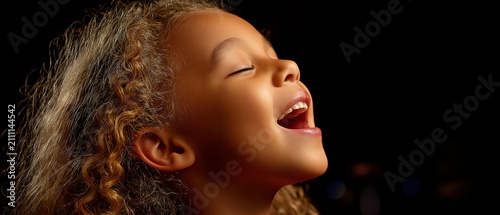 Child singing with closed eyes