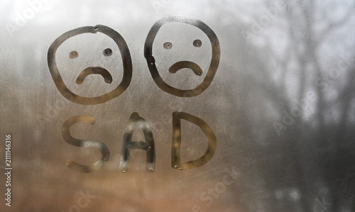 Bild auf Leinwand Sad word appears on fogged window glass with two unhappy faces