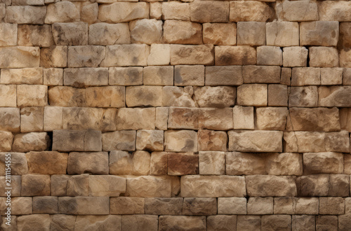 Processed collage of old ancient sand block wall texture in daylight. Background for banner.