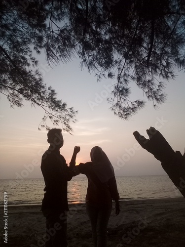 couple on the beach at sunset