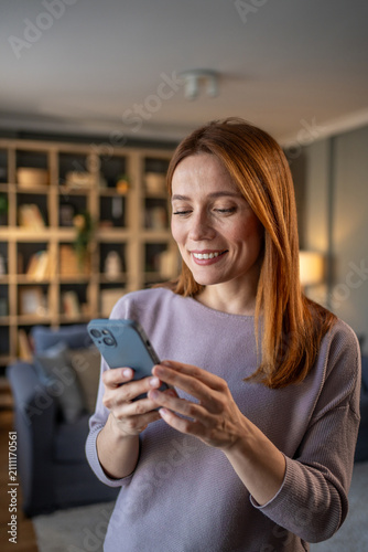 Woman smiling while using smartphone for communication and networking