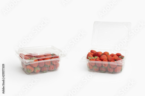 Fotografie Fresh red strawberries in clear plastic clamshell packaging containers showing o