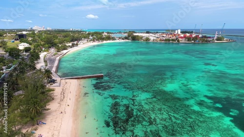 Nassau, Bahamas: Aerial view of turquoise sea, white sand beach and coastal road on New Providence island - landscape panorama of the Caribbean from above
