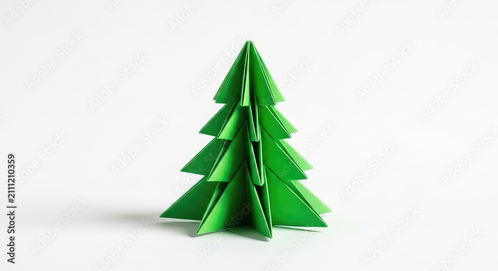 Obraz premium Origami fir tree made from bright green paper stands centered on a plain white surface, showcasing a modern and simple holiday aesthetic, art, yuletide, copy space