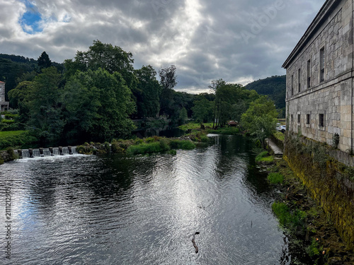 Obraz na plátně River passing stone building and weir on Camino de Santiago Spain