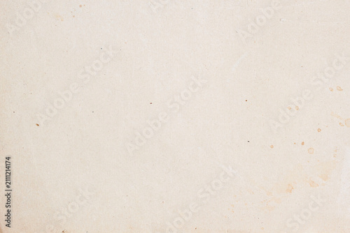Light aged paper texture with subtle fibers, faded marks and small natural stains. Neutral vintage background, copy space, craft design