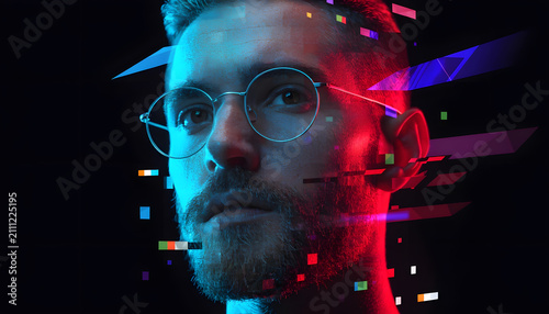 Cyberspace meta environment and high technology programming. AI data analysis and developer workspace. Young smart man with glasses looking up amid neon floating pixel geometric blocks