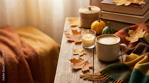 Coffee mug and books on an autumn desk.