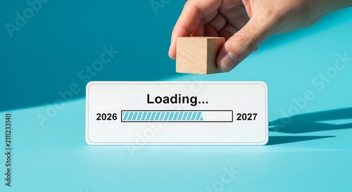 Hand placing a wooden block on a 2026 to 2027 loading bar