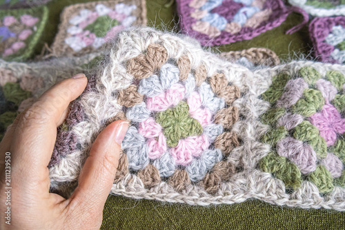 Fotografía Female hand sliding over soft angora granny squares, enjoying texture