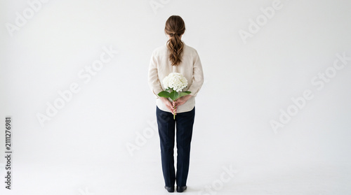 Back view of a person standing against a pure white background.