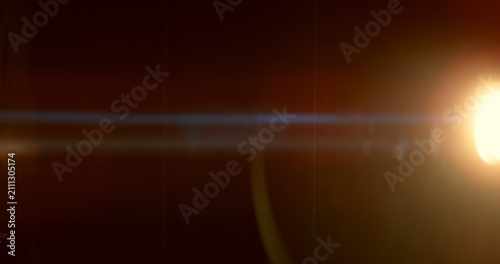 Warm anamorphic lens flare overlay featuring a golden light source, blue horizontal light streak, realistic optical reflections and subtle glow on a black background. Premium VFX asset.